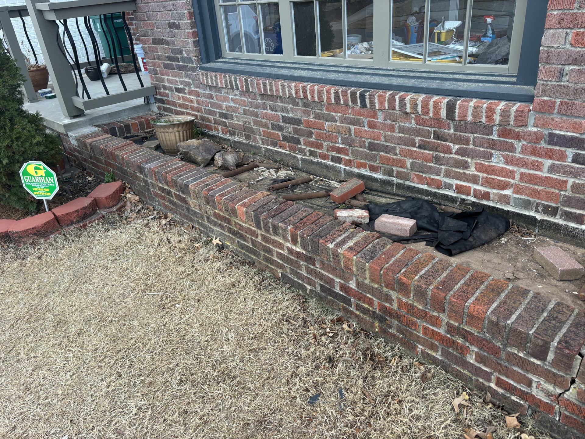 Brick planter bed before cleanup