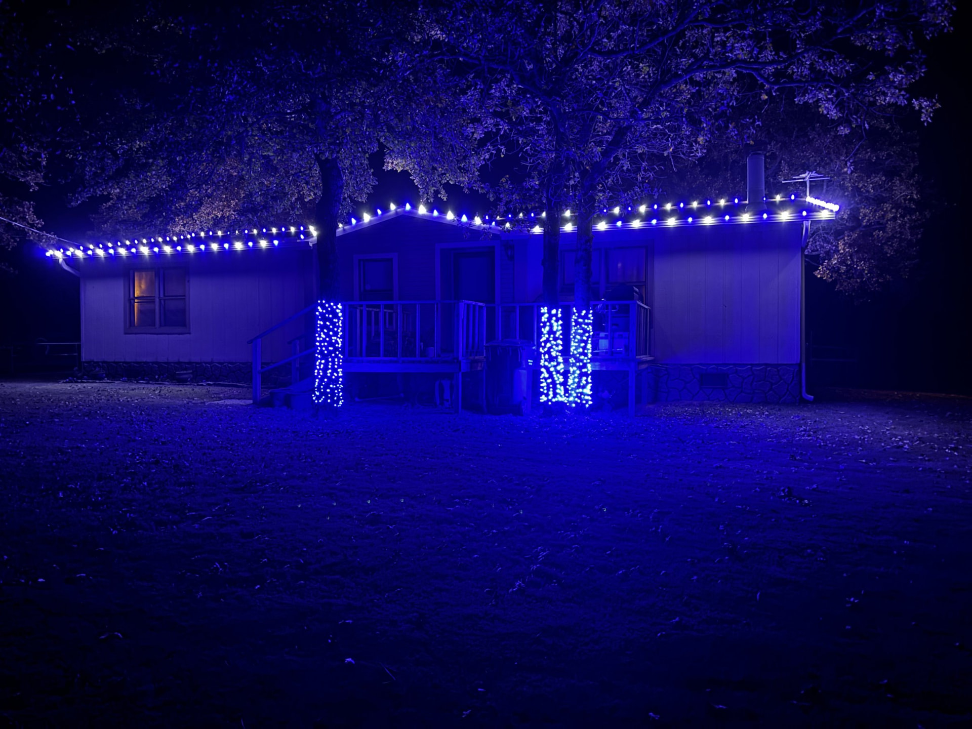 Blue roofline Christmas lights on a home