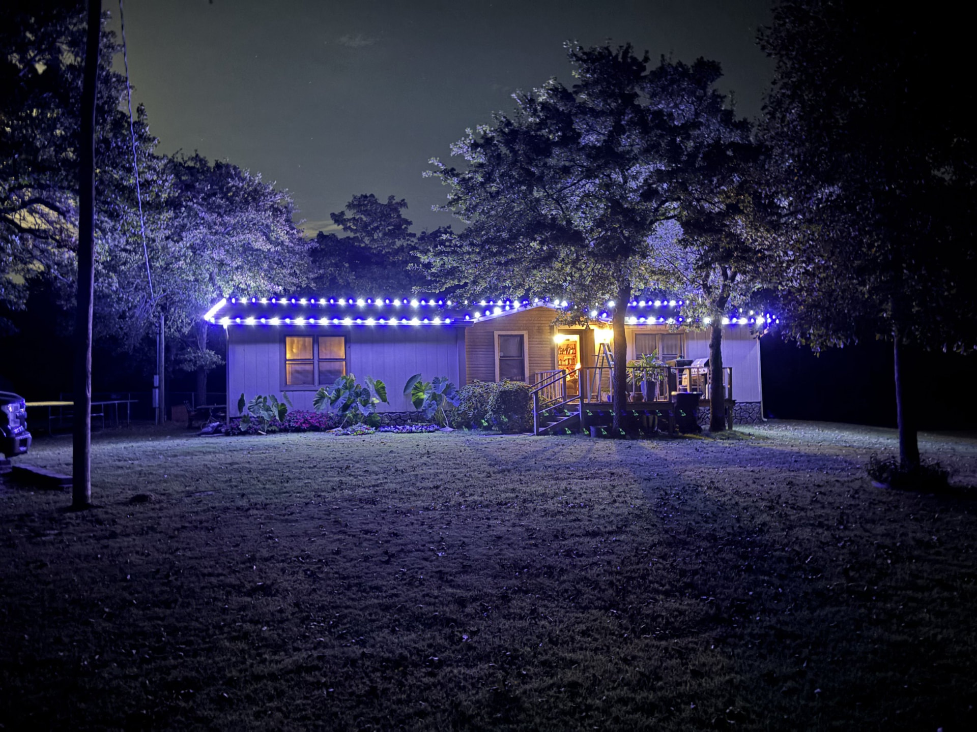 Home lit up with Christmas lights at night in the OKC metro